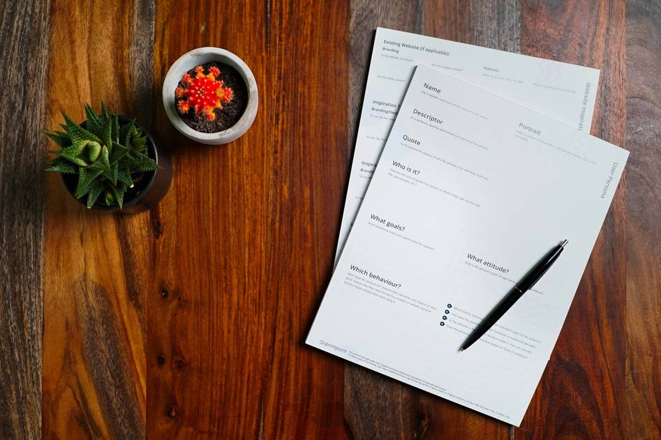 Person reviewing home insurance documents with a magnifying glass