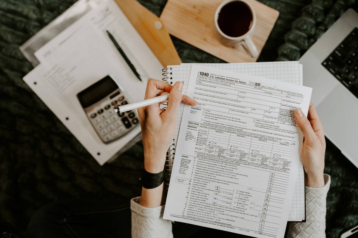 Inventory Valuation Guide showing a homeowner organizing receipts and taking photos of electronics